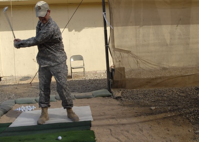 Lt. Col. Christopher Beckert, from Madison, Conn., deputy commander, 2nd Heavy Brigade Combat Team, 1st Infantry Division, Multi-National Division-Baghdad, practices his drive at the newly installed "Dagger" driving range at Camp Liberty Feb. 8.  A v...