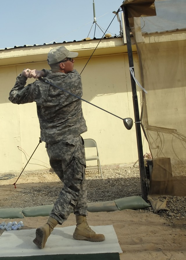 Col. Joseph Martin, commander, 2nd Heavy Brigade Combat Team, 1st Infantry Division, Multi-National Division - Baghdad, hits the first ball at the grand-opening of the "Dagger" driving range on Camp Liberty Feb. 8. The Dearborn, Mich., native christe...