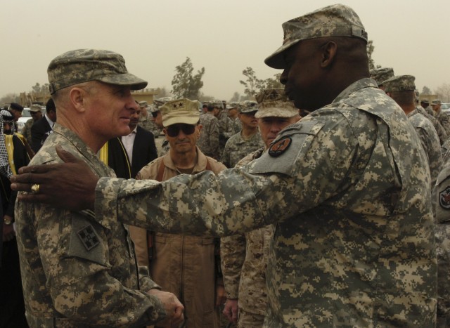CAMP LIBERTY, Iraq - Lt. Gen. Lloyd Austin III (right), commanding general of Multi-National Corps-Iraq, says goodbye to Maj. Gen. Jeffery Hammond, commanding general of 4th Infantry Division, during the transfer of authority ceremony at Camp...