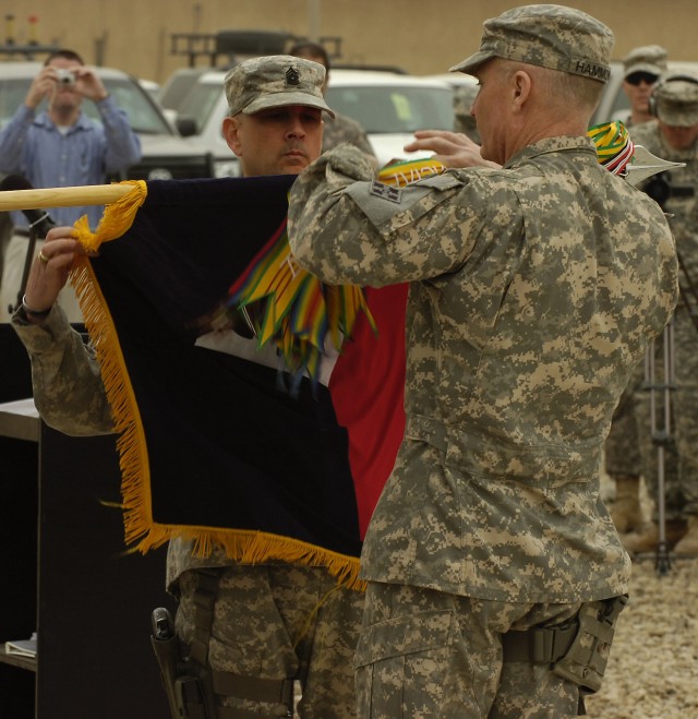 CAMP LIBERTY, Iraq - Command Sergeant Major John Gioia (left), senior enlisted leader of 4th Infantry Division, and Maj. Gen. Jeffery Hammond, commanding general of 4th Inf. Div., case the division's colors during the transfer of authority...