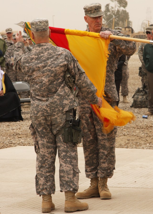 CAMP LIBERTY, Iraq - Maj. Gen. Daniel Bolger (right), commanding general of 1st Cavalry Division, Multi-National Division-Baghdad, and Command Sgt. Maj. Rory Malloy, senior enlisted leader of 1st Cav. Div., MND-B, uncase their division's colors...