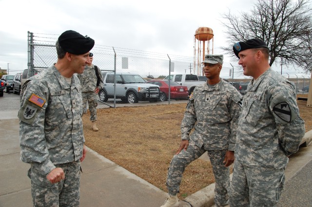 Lt. Col. Charles Dalcourt (center), commander of the 1st Attack Reconnaissance Battalion, 227th Aviation Regiment, 1st Air Cavalry Brigade, 1st Cavalry Division, along with 1st Sgt. James Combs (right), acting command sergeant major for 1-227th, gree...