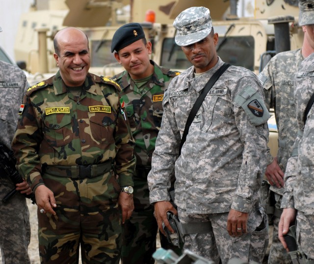Pineville, La. native, Col. Owen Monconduit, commander of the 225th Engineer Brigade, 1st Cavalry Division, Multi-National Division- Baghdad, enjoys a good laugh with Col. Ahmed-Alswedy, commander of the 6th IA engineers, during a tour of Col....