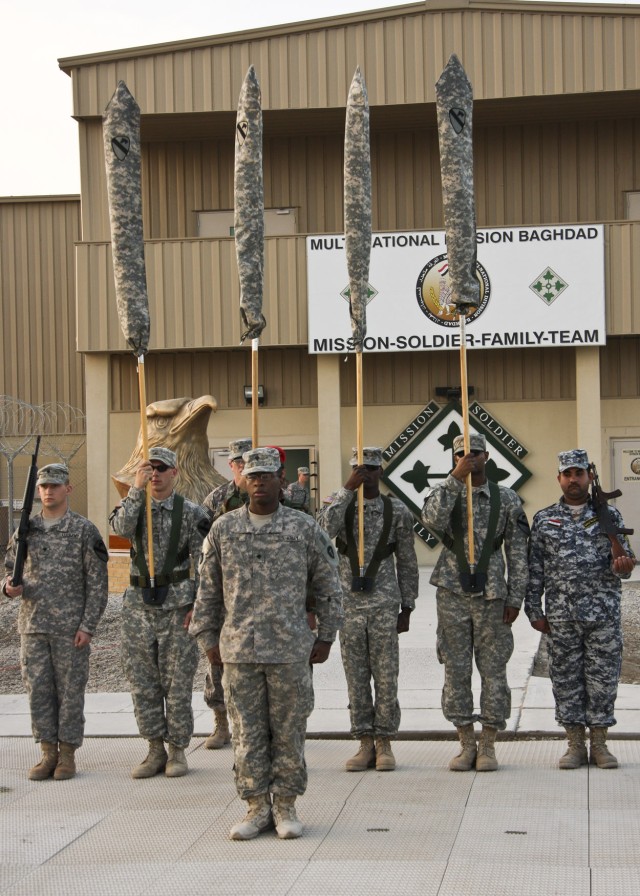 CAMP LIBERTY, Iraq - Multi-National Division-Baghdad Soldiers, along with an Iraqi Soldier and a National Policeman, practice color guard drills in front of division headquarters on Camp Liberty Feb. 8.  The group practices movements in...