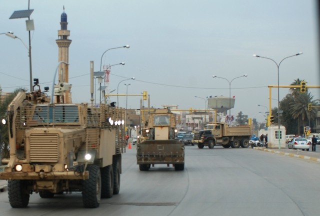 Soldiers from the 688th Mobility Augmentation Company, 890th Engineer Battalion, 926th Engineer Brigade, Multi-National Division - Baghdad search the busy streets of Baghdad for rubbish and explosive devices during a routine route sanitation mission ...