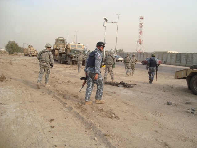 BAGHDAD - A joint security element composed of Soldiers from 2nd Battalion, 14th Cavalry Regiment, 2nd Brigade, 25th Infantry Division and the 6th Iraqi Army prepare to move into position to secure the roadways for route sanitation near the...
