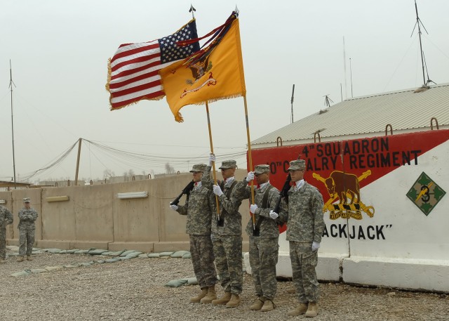 BAGHDAD - Members of a flag detail with the 4th Squadron, 10th Cavalry Regiment "Blackjack", attached to the 2nd Heavy Brigade Combat Team, 1st Infantry Division, Multi-National Division - Baghdad stand at the position of attention during their Trans...