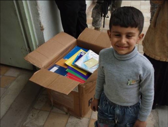 BAGHDAD - A student at the Abi Tammam Boys Primary School smiles while receiving school supplies Feb. 10 in the Karkh district of northwest Baghdad.  Soldiers from the 4th Battalion, 42nd Field Artillery Regiment, attached to the 2nd Heavy Brigade...