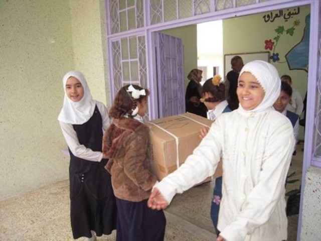 BAGHDAD - Students at the Uroba School in the Karkh district of northwest Baghdad receive school supplies with smiles Feb. 10.  Multi-National Division-Baghdad Soldiers from the 4th Battalion, 42nd Field Artillery Regiment, attached to the 2nd...