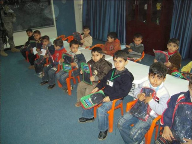 BAGHDAD - Students at the Abi Tammam Boys Primary School receive back packs from Multi-National Division-Baghdad Soldiers during a school supply delivery Feb. 10 in the Karkh district of northwest Baghdad.  The Soldiers, from the 4th Battalion,...