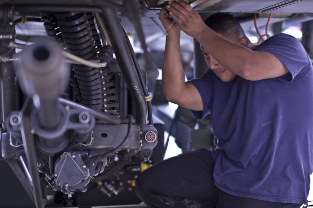 Francisco Landin, a contractor from White Salmon, Wash., installs modifications on the AH-64D Apache helicopters for 4th Attack Reconnaissance Battalion, 227th Aviation Regiment, 1st Air Cavalry Brigade, 1st Cavalry Division, Feb. 9, Fort Hood, at Te...