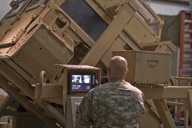 Soldiers from the 1st Air Cavalry Brigade, 1st Cavalry Division, brace themselves inside the simulated humvee, while  Odessa, Texas, native Sgt. 1st Class Jeremy Weisheit, the operations platoon sergeant for 1st ACB, tilts the humvee to its...