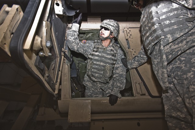 After flipping a couple of times, El Paso, Texas, native 2nd Lt. Nora Soto, the strength manager for the 1st Air Cavalry Brigade, 1st Cavalry Division, climbs out of the overturned HMMWV Egress Assistance Trainer with a little help from Chyenne,...