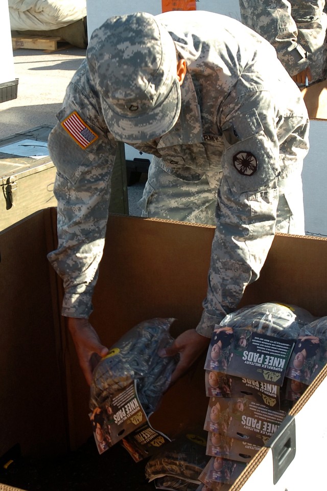 Pfc. Quaterric Johnson, with the 565th Quartermaster Company, Special Troops Battalion, 15th Sustainment Brigade, 13th Sustainment Command (Expeditionary), stacks knee pads for processing as a part of Operation Clean Sweep, a program designed to rid ...