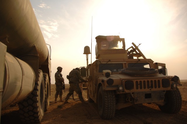 Soldiers refuel vehicles