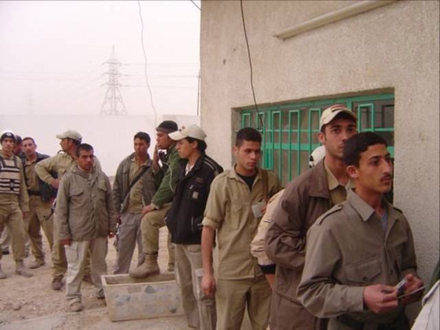 BAGHDAD - Members of the Sons of Iraq from the Yarmouk and Hateen neighborhoods wait in line to receive their pay in the Mansour district of northwest Baghdad Feb. 10.  The Government of Iraq assumed fiscal responsibility of the SOI late last year...