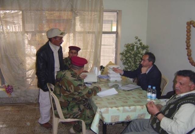 BAGHDAD – Iraqi Officials and Iraqi Army Soldiers serving with the 2nd Battalion, 54th Brigade, 6th Iraqi Army Division work out payments with members of the Sons of Iraq in the Mansour district of northwest Baghdad Feb. 10. More than 60 SoI...