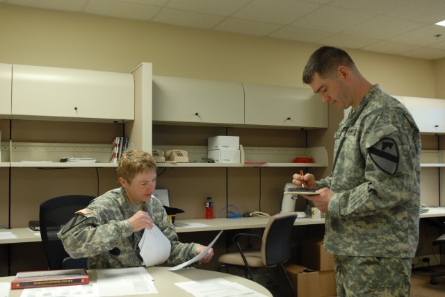 1st Sgt. Dara Wylder (left), acting sergeant major, 1st Air Cavalry Brigade (Rear), 1st Cavalry Division, of Houston, and Maj. Daniel Legereit, of Metropolis, IL, commander of the 1st ACB (Rear), 1st Cav. Div., inspect paperwork following the...