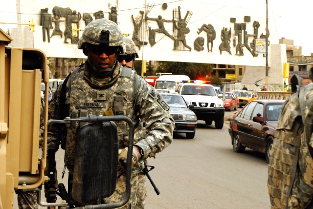 BAGHDAD - Col. Byron Freeman, the commander of the 8th Military Police Brigade, Multi-National Division-Baghdad and a native of Norfolk, Va., arrives at a checkpoint to observe operations near a busy intersection during a battlefield circulation...