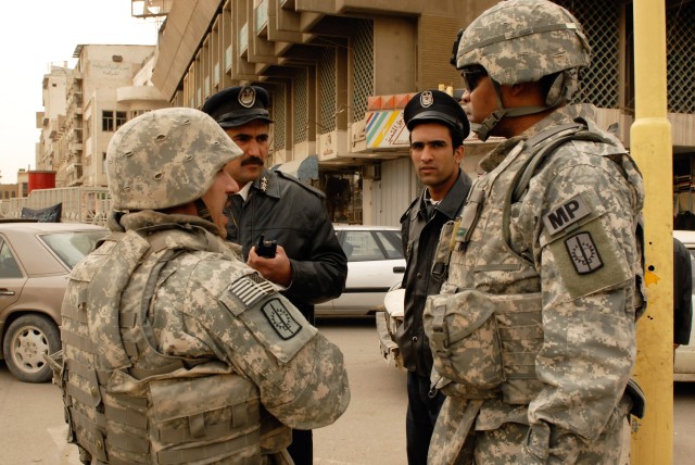 BAGHDAD - Col. Byron Freeman (right), commander of the 8th Military Police Brigade, Multi-National Division-Baghdad and a native of Norfolk, Va., visits a checkpoint Feb. 14 during the heightened security implementations throughout the city in...