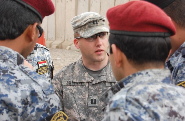JOINT SECURITY STATION ISTAQLAL, Iraq – Capt. Greg Holloway, 1st Battalion, 112th Infantry Regiment, 56th Stryker Brigade Combat Team, Pennsylvania Army National Guard, discusses an upcoming air assault mission with members of the 2nd Brigade,...
