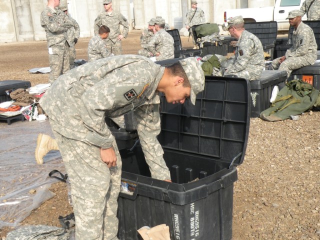 CAMP LIBERTY, Iraq - Spc. Charles Gamache, a native of Pontotoc, Miss., inventories the items in his black box Feb. 9, before loading it on the shipping container headed back to the United States. The Soldiers of the 890th Engineer Battalion, of Gulf...