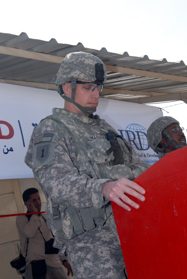 BAGHDAD - Col. Joseph Martin, a native of Dearborn, Mich., commander, 2nd Heavy Brigade Combat Team, 1st Infantry Division, Multi-National Division - Baghdad prepares to speak at the re-opening ceremony of the Shawaka Fish Market in the Karkh...