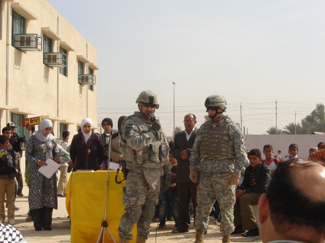 Baghdad- El Paso Texas native, Lt. Col. Rich Morales (left), commander of 1st Battalion, 35th Armored Regiment, MND-B, speaks during the ribbon cutting celebration at Al Ghasacena Primary School in Jurf Nadaf West Feb. 12. The newly refurbished...