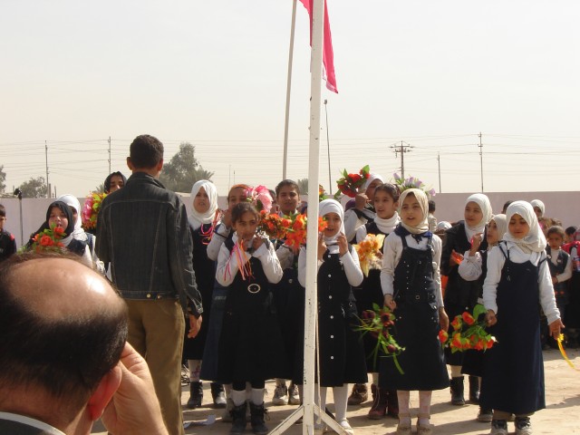Baghdad- A girl's class performs a song in celebration at the ribbon cutting celebration for the Al Ghasacena Primary School in Jurf Nadaf West celebrating the completion of a major refurbishment to the school, Feb. 12. The newly refurbished...