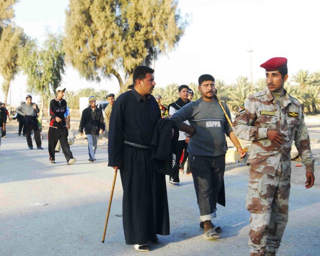 LUTIFIYAH, Iraq -A soldier of the 17th IA Division provides security during the Arba'een march in Lutifiyah on Feb. 12.  MND-B Soldiers and their Iraqi Security Force partners patrolled the road ways and visited IA checkpoints in Lutifiyah during the...