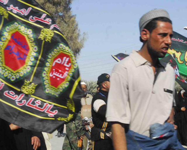 LUTIFIYAH, Iraq -Shia Muslims celebrate Arba'een in Lutifiyah Feb. 12. The Iraqis marched on foot from Baghdad to the holy city of Karbala singing and waving religious flags.  MND-B Soldiers and their Iraqi Security Force partners patrolled the road ...