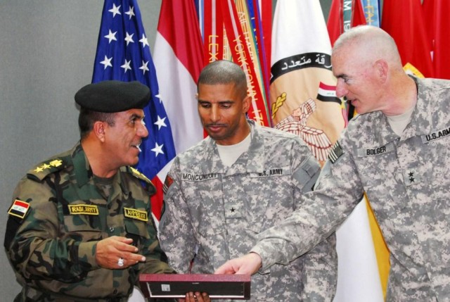 BAGHDAD -Col. Ahmed Khalifa (left), commander, 6th Iraqi Army Engineers, presents newly promoted Brig. Gen. Owen Monconduit (center) of Pineville, La., a gift in celebration of the newest general officer in Multi-National Division-Baghdad during a ce...