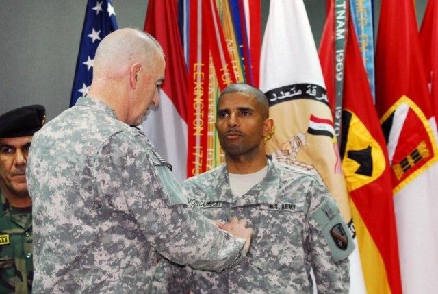 BAGHDAD - Maj. Gen. Daniel P. Bolger, commander of the 1st Cavalry Division, Multi-National Division-Baghdad, places Brig. Gen. Owen Monconduit's first star during his promotion ceremony Feb. 17. Monconduit, of Pineville, La., is the first African-Am...