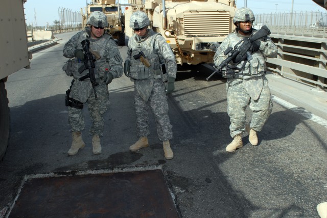 BAGHDAD - Command Sgt. Maj. Frank Thibodeau (left), the senior enlisted advisor of the 46th Engineer Battalion from Fort Polk, La., attached to the 225th Engineer Brigade, and Lt. Col. Matthew Zajac (center), commander of the 46th Eng. Bn., inspect a...