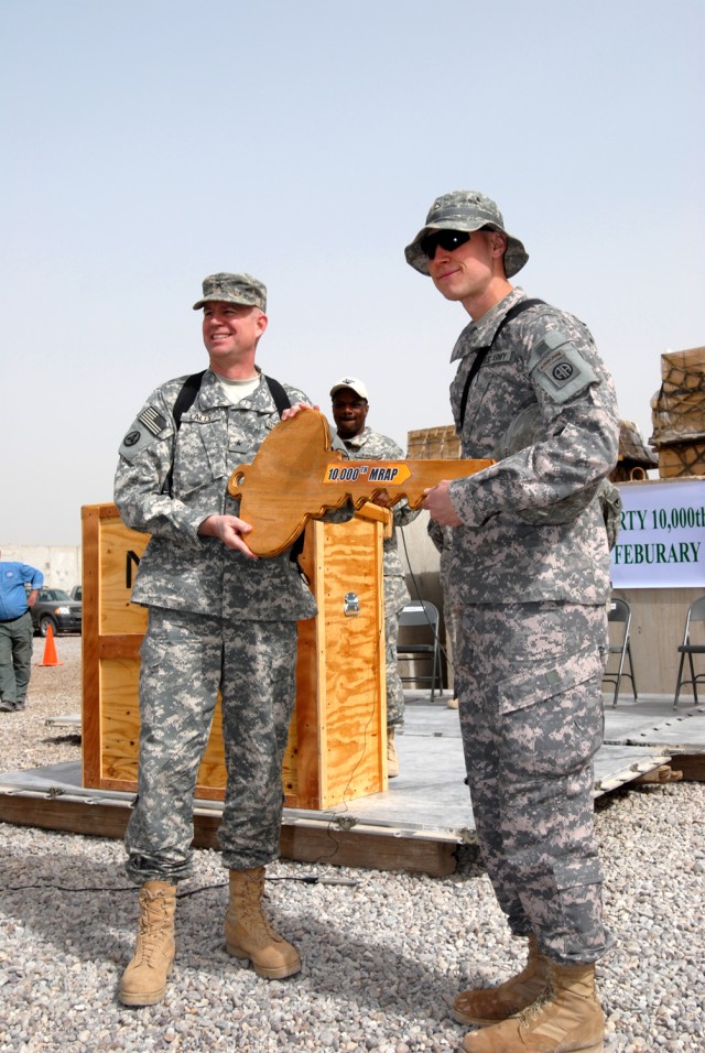 CAMP LIBERTY, Iraq - Pfc. Derek Sharp (right), a native of Greenville, Mich., with the 5th Squadron, 73rd Cavalry Regiment, 3rd Brigade, 82nd Airborne Division, Multi-National Division-Baghdad,receives a symbolic key from Brig. Gen. Michael Lally , c...