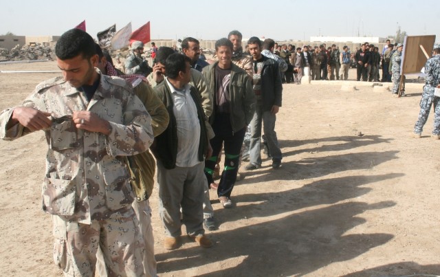 ISTAQLAL, Iraq -Son of Iraq members go through a series of security and identification checks during a SoI payment event Feb. 19 in the Istaqlal Qada district of Baghdad.  The Government of Iraq paid more than 500 SoI members their monthly salary of ...