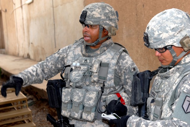 BAGHDAD - Staff Sgt. Edward Davis (left), a construction supervisor from New Orleans, and Cpl. Mark Leon Guerrero, a carpentry mason from Tamuning, Guam, do a site reconnaissance for a dining facility at Joint Security Station Saab Al Bour in...