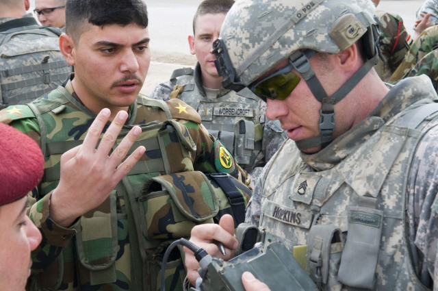 BAGHDAD - Staff Sgt. James Hopkins, with 1st Battalion, 7th Field Artillery Regiment, 2nd Heavy Brigade Combat Team, 1st Infantry Division, Multi-National Division-Baghdad, addresses questions from Iraqi Army officers at the International Zone in...
