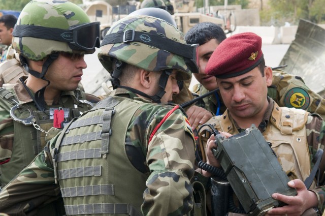 BAGHDAD -Soldiers of the Iraqi Army practice basic functions with their radio equipment after a class given by Soldiers of 1st Battalion, 7th Field Artillery Regiment,  2nd Heavy Brigade Combat Team, 1st Infantry Division, Multi-National...