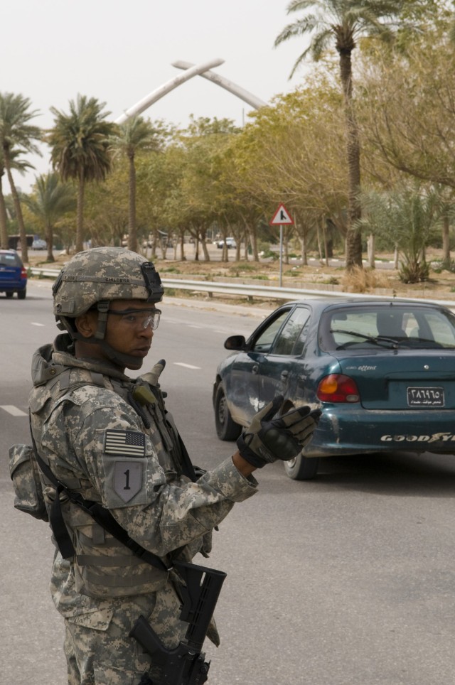 BAGHDAD - Pfc. Christopher Childers, 1st Battalion, 7th Field Artillery Regiment,  2nd Heavy Brigade Combat Team, 1st Infantry Division, Multi-National Division-Baghdad, conducts traffic control point operations at the International Zone Feb. 14....
