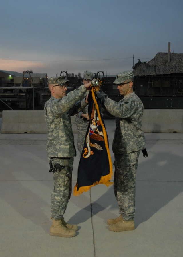 CAMP TAJI, Iraq - Lt. Col. Mark O'Hanlon (left), of Wallingford, Pa., commander of the 1st Battalion, 111th Infantry Regiment, 56th Stryker Brigade Combat Team, Pennsylvania National Guard, unfurls the battalion colors with the Command Sgt. Maj....
