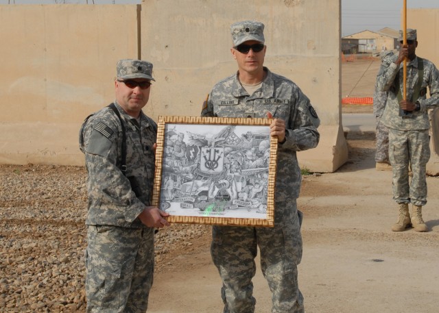 CAMP TAJI, Iraq - Lt. Col. Michael Curran (left), commander of the 328th Brigade Support Battalion, 56th Stryker Brigade, Pennsylvania National Guard, receives a framed print from Lt. Col. Mark Collins, commander of the 2nd Brigade, 25th Infantry BSB...