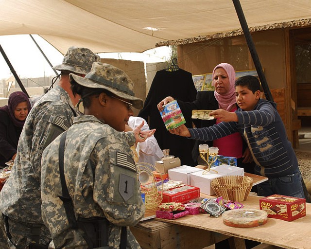 BAGHDAD- Soldiers from Task Force 1st Combined Arms Battalion, 63rd Armor Regiment buy from a vendor during the Women's Bazaar at FOB Mahmudiya Feb 17. The Women's Bazaar allowed the local women to improve their small businesses and take care of thei...