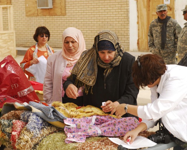 BAGHDAD- A local Iraqi woman from the Mahmudiyah Qada discusses her products with a customer during the Women's Bazaar hosted by Task Force 1st Combined Arms Battalion, 63rd Armor Regiment at FOB Mahmudiyah Feb 17.  Many of the women in the...
