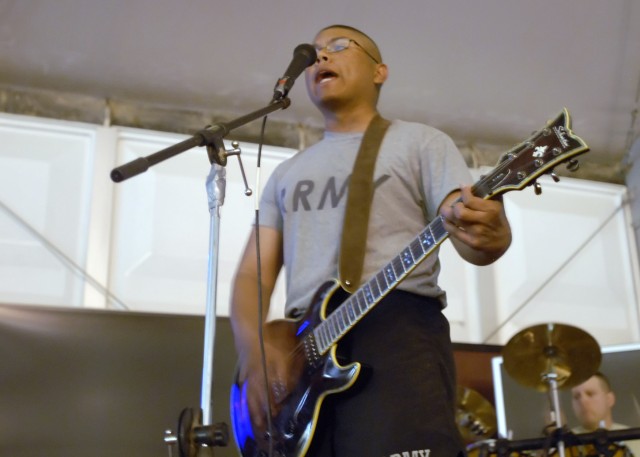 BAGHDAD - Pfc. Daniel Gonzales (front), a native of Miami, Fla., and Spc. Jeremy Kattner (back), a native of Brew City, Wis., both with Brigade Special Troops Battalion, 2nd Heavy Brigade Combat Team, 1st Infantry Division, perform a song by the...