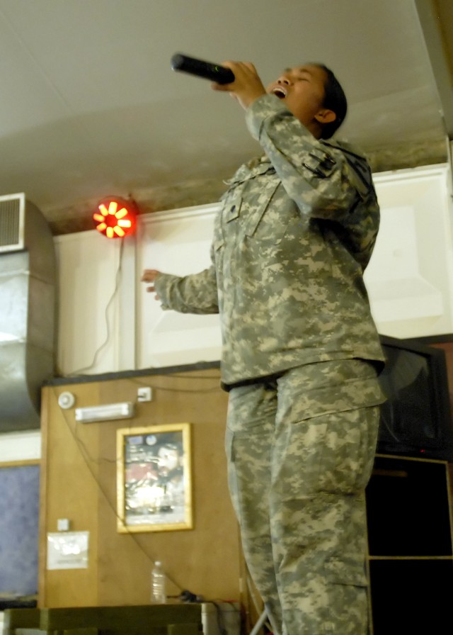 BAGHDAD - Spc. Katrina Goss, a native of Killeen, Texas, Division Special Troops Battalion, 1st Cavalry Division, performs the song, No One by recording artist Alicia Keys in a talent show at Camp Liberty Feb. 20. Goss placed 2nd in the contest,...