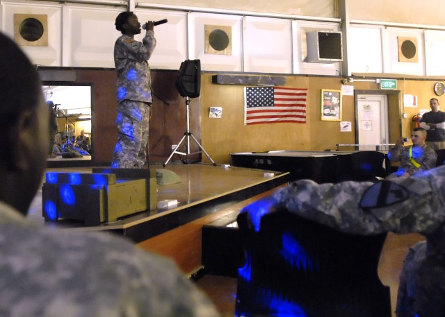 BAGHDAD - Sgt. Aliesha Turner, a native of Midway, Ala., Division Special Troops Battalion, 1st Cavalry Division, sings the event winning song she wrote; Me and You, at the "Night at the Apollo" talent show hosted by the Brigade Special Troops...