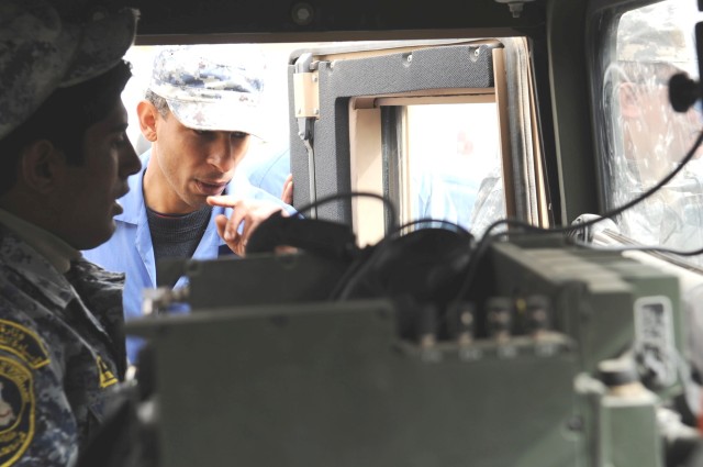 JOINT SECURITY STATION BELADIYAT, Iraq - National Police mechanics assigned to the 8th Brigade, 2nd NP Division, watch indicators and gauges on the dashboard of an up-armored humvee during a class on fault diagnosis and troubleshooting techniques...
