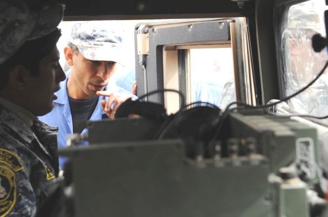 JOINT SECURITY STATION BELADIYAT, Iraq - National Police mechanics assigned to the 8th Brigade, 2nd NP Division, watch indicators and gauges on the dashboard of an up-armored humvee during a class on fault diagnosis and troubleshooting techniques Feb...