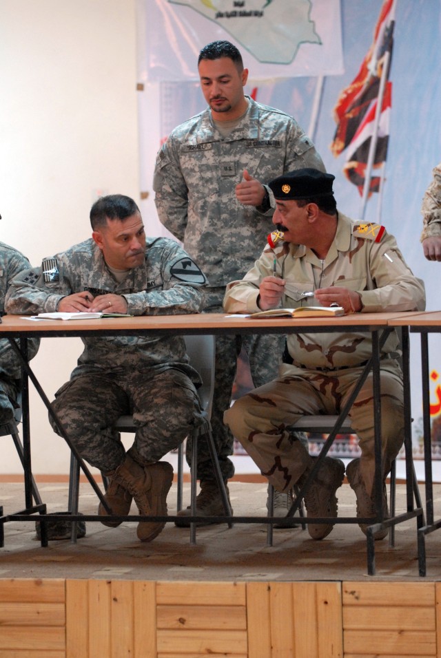 Maj. Gen. Abdul Ameer, the 12th Iraqi Army Division commander and Col. Ryan Gonsalves, the commander of the 2nd Brigade Combat Team, 1st Cavalry Division, sit with a translator between them at K-1, a military base in Kirkuk Province, Feb. 5. The...